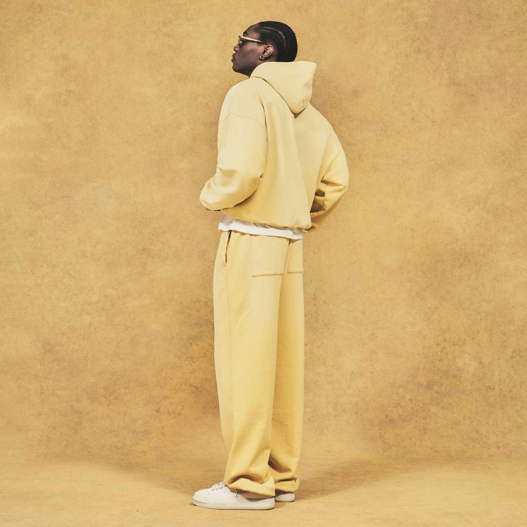 Model wearing the Initial Oversized Hoodie and Sweatpant in Canary Yellow