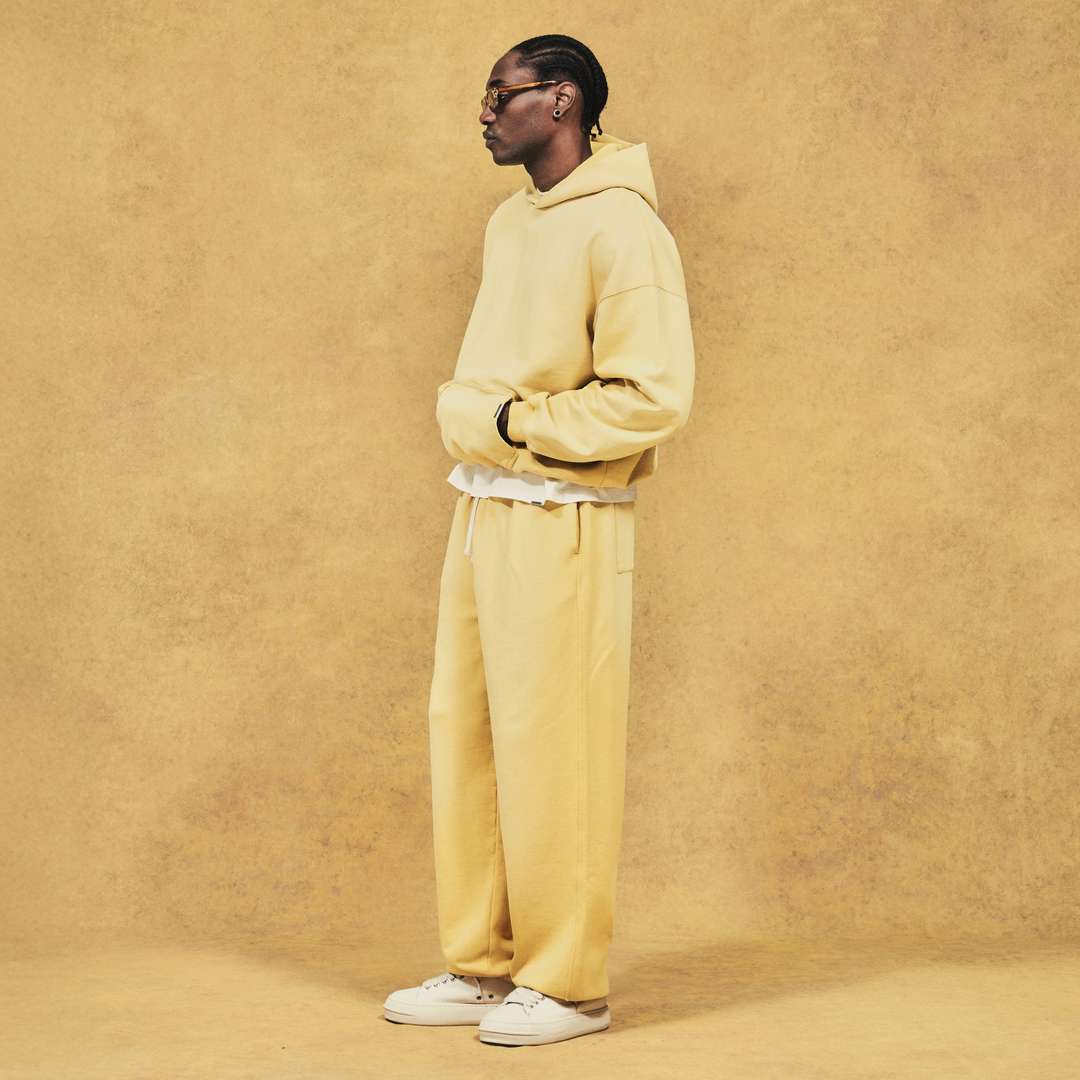 Model wearing the Initial Oversized Hoodie and Sweatpant in Canary Yellow
