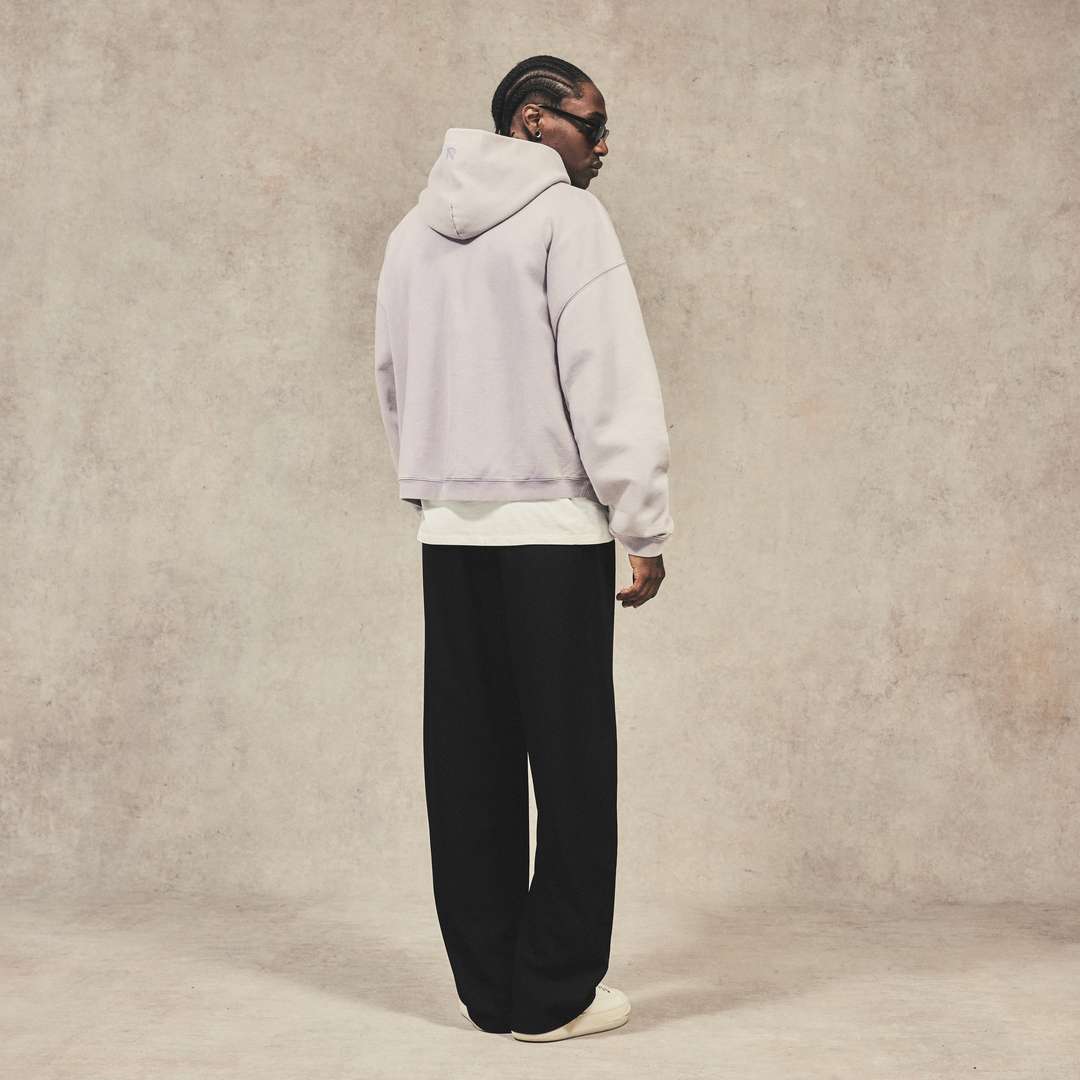 Model wearing the Initial Boxy Hoodie in Mist
