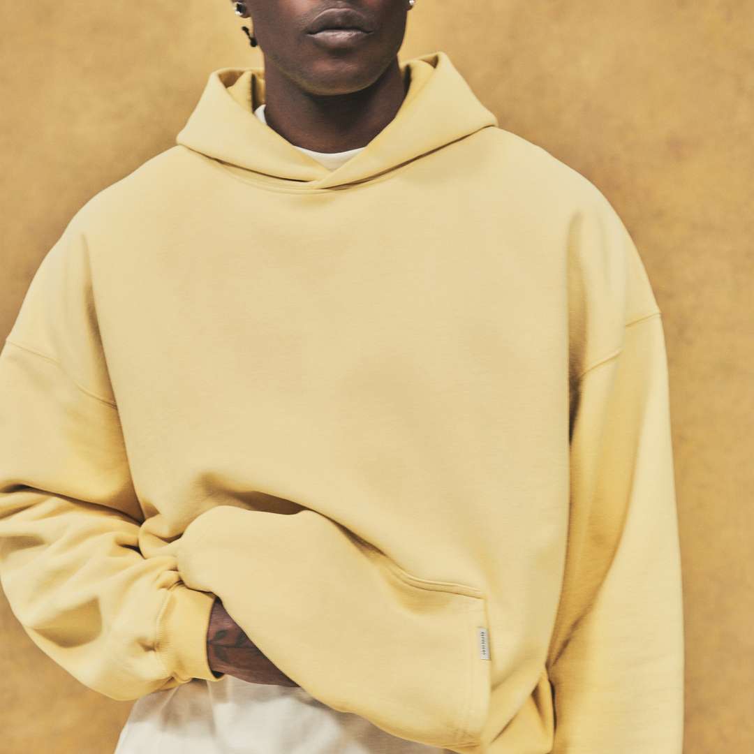 Model wearing the Initial Oversized Hoodie and Sweatpant in Canary Yellow