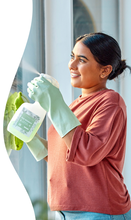 Woman smiling while cleaning a window
