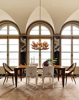 A dining room with large picture windows.
