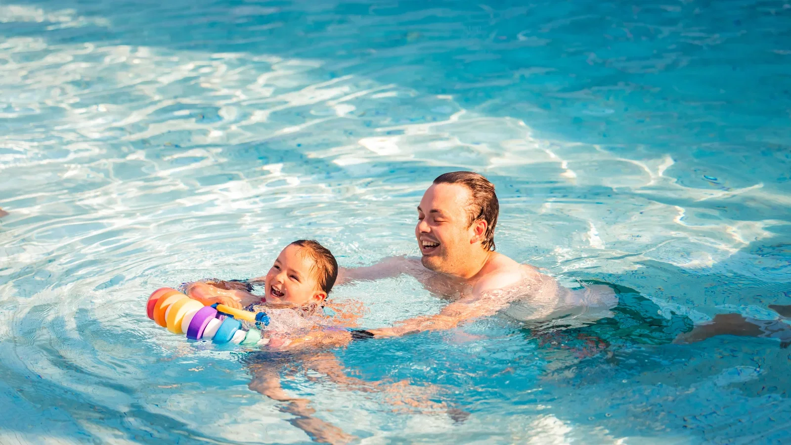 father and daughter swimming at the blue lagoon