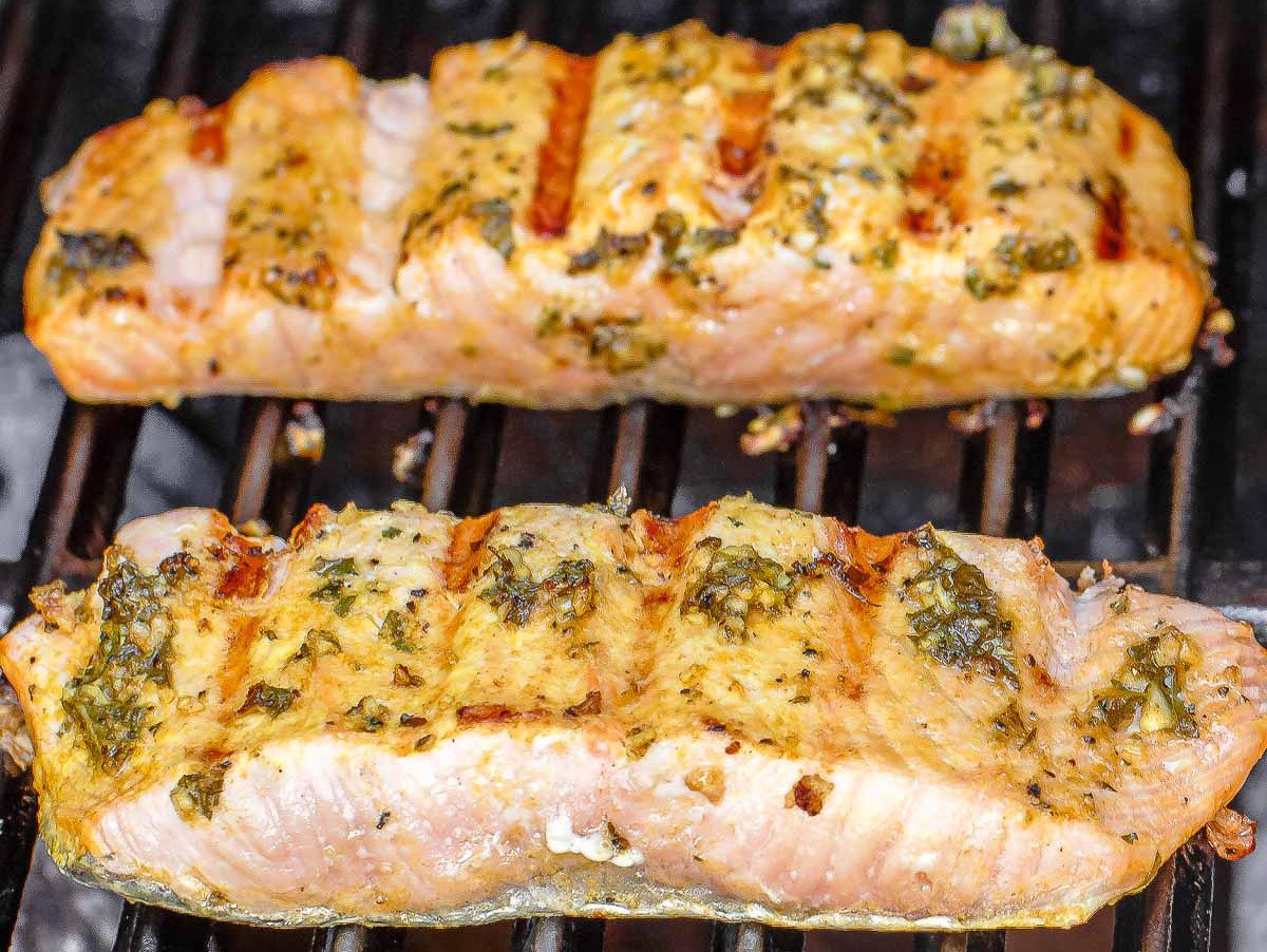 Two salmon fillets on a grill. 