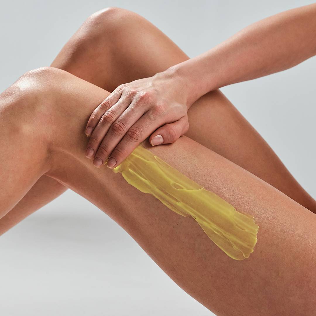 Woman applying Sun Soul Tan Maximizer on her legs