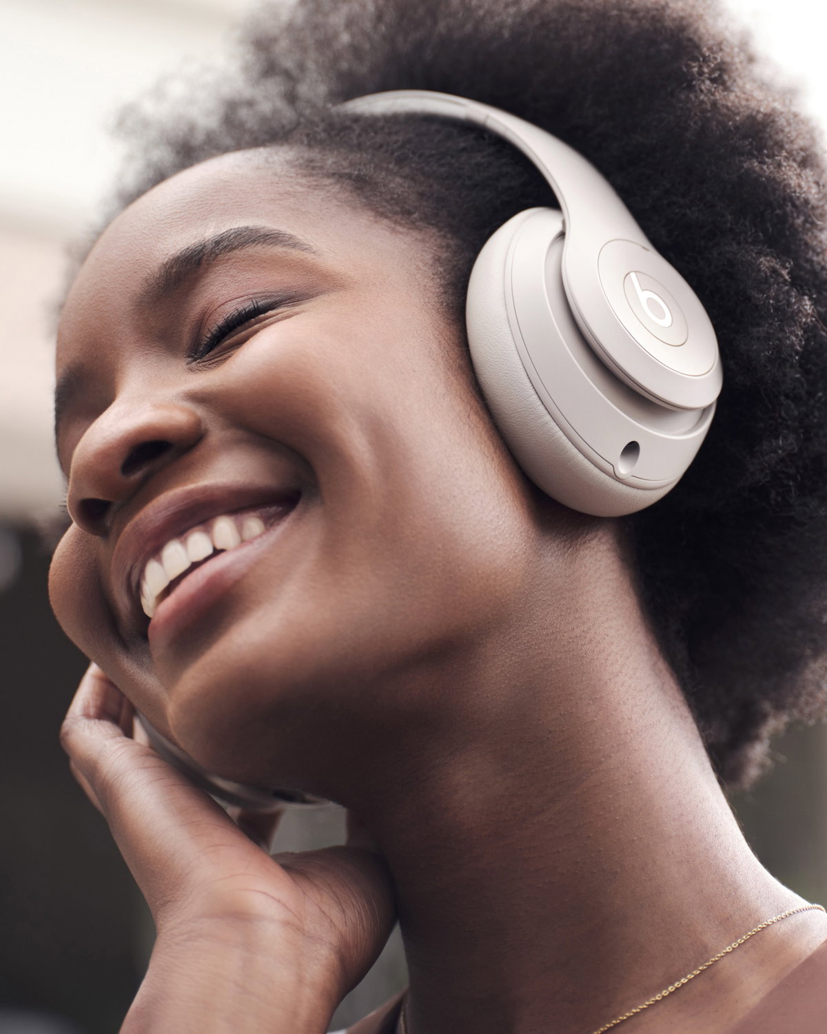 Woman wearing Beats Studio Pro headphones