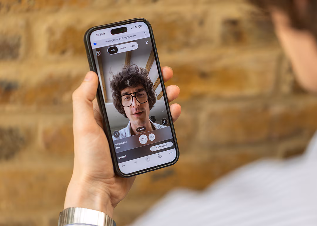 A man using a smartphone to virtually try on glasses