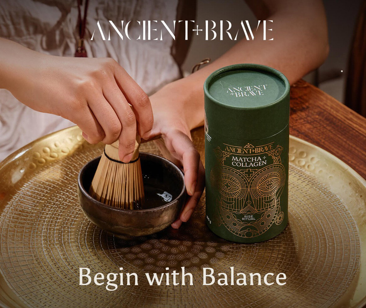Matcha + Collagen being made with a bamboo whisk.