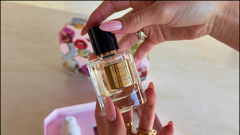 KYOTO IN BLOOM EAU DE PARFUM BEING HELD BY HANDS WITH PINK NAILS