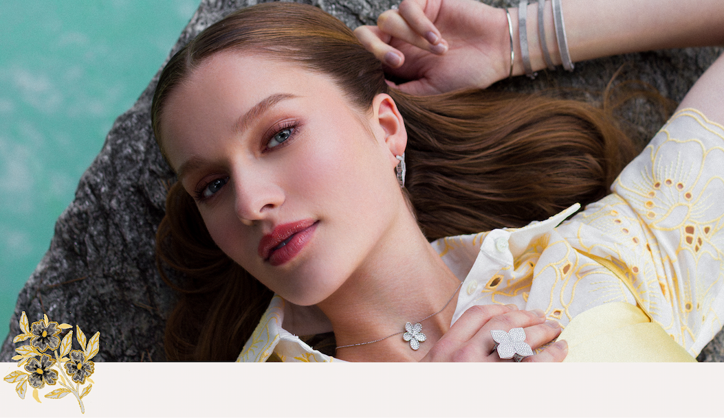 Woman wearing Roberto Coin jewelry while laying down