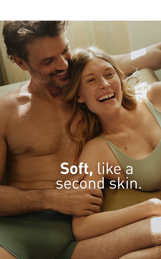 The female model is wearing panties and a bustier in Tea Green from CALIDA's Natural Skin series, and the male model is wearing green boxer briefs from CALIDA's Balanced Day series. 