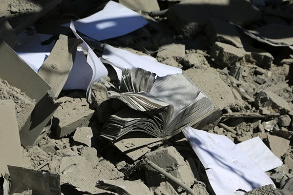 Torn pages from academic books scattered amongst the rubble from the explosion at Sharif University of Technology.