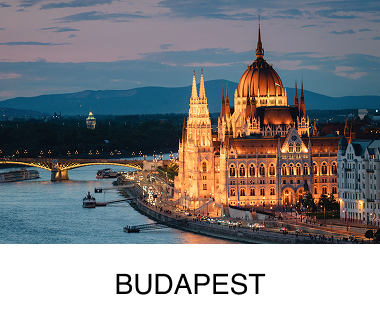 An ornate city building lit up at night, glowing and surrounded by water, an urban setting appears in the background. Text reads: Budapest.