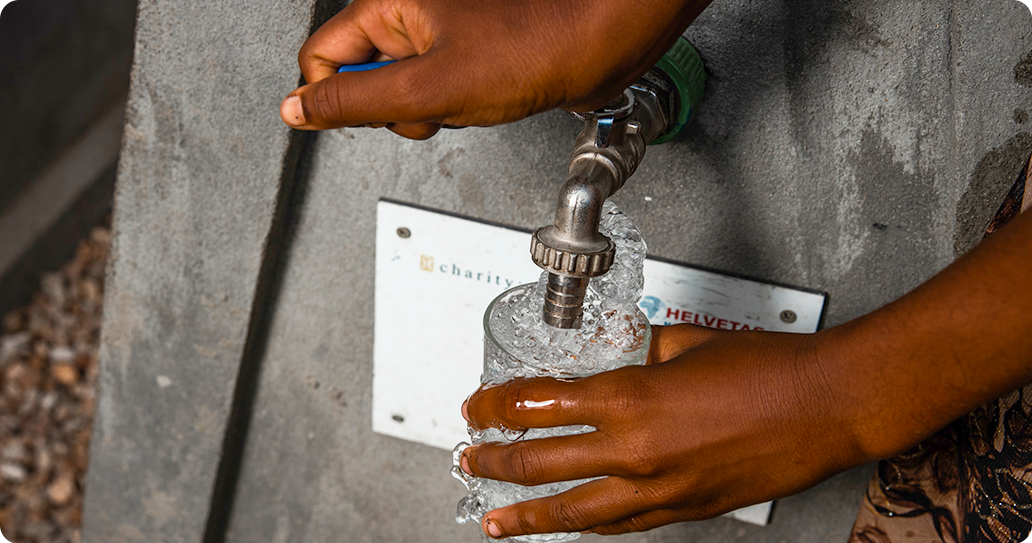 Someone getting clean water from a tap stand.