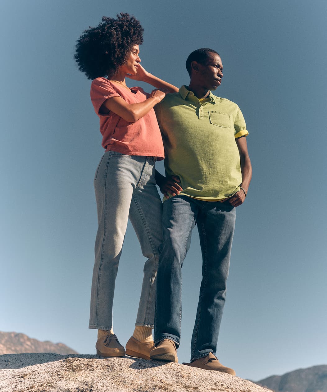 Man and woman in sunwashed tees and polo.