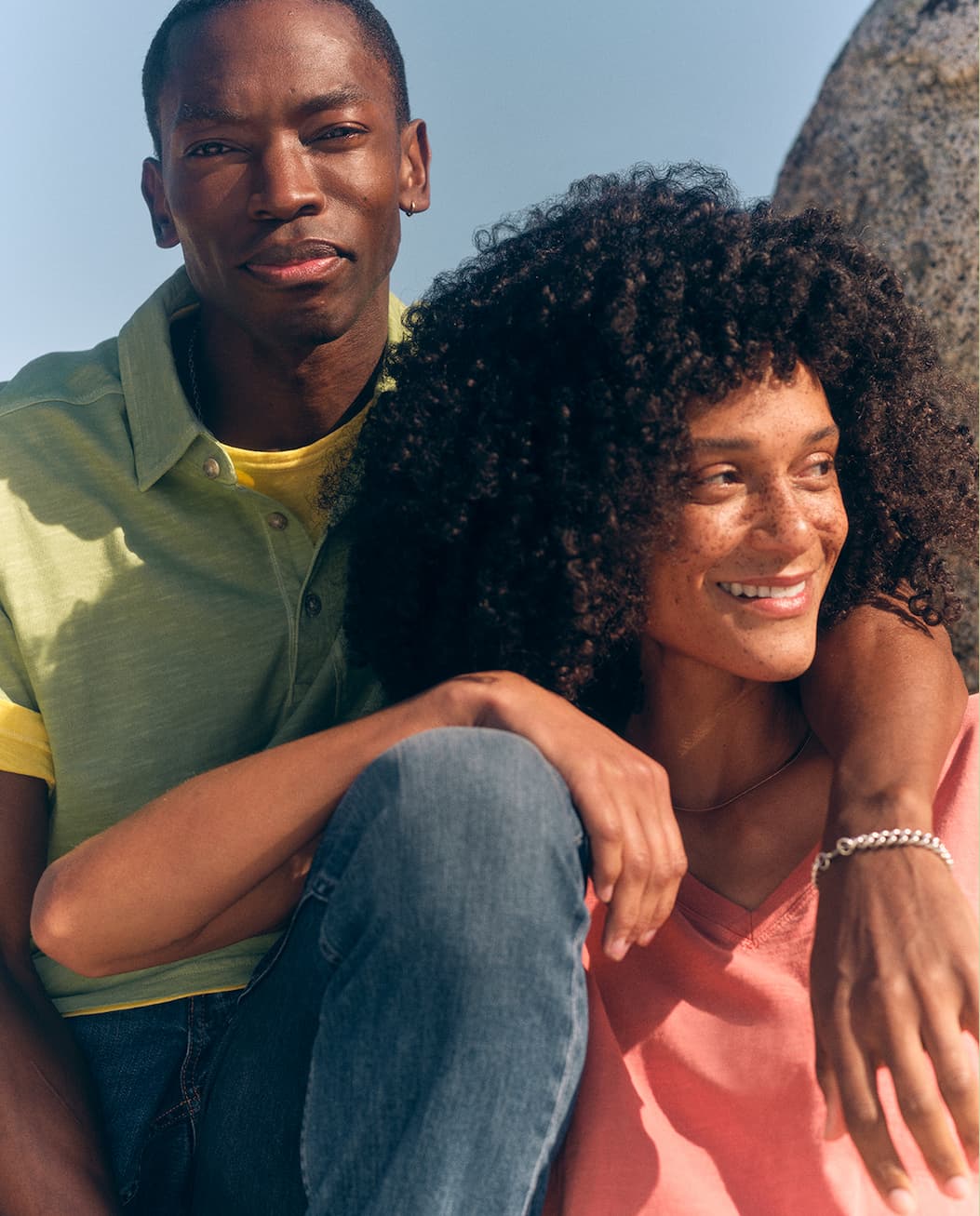 Man and woman in sunwashed tees and polo.