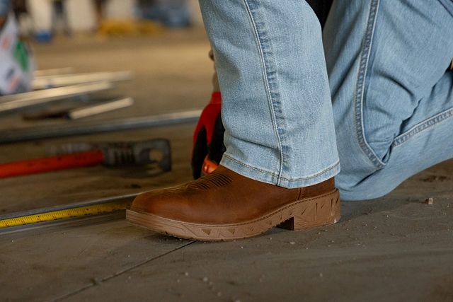 A man wearing the Markout 11" Steel Toe in brown.