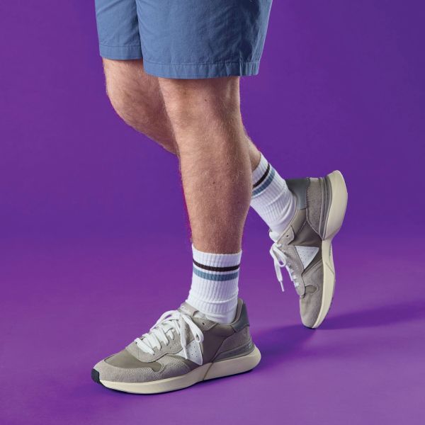 Model wearing Clarks trainers