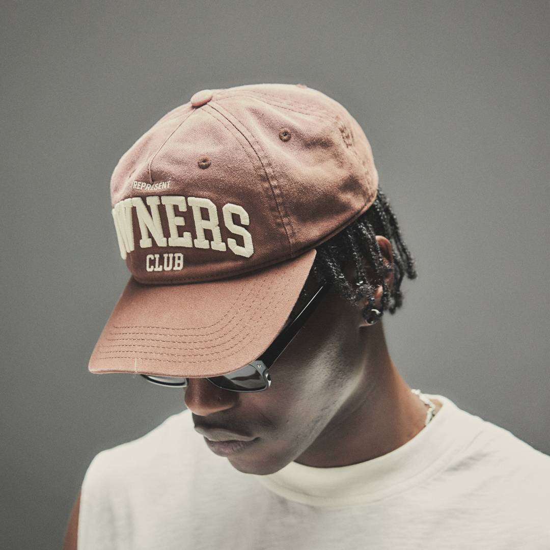 Model wearing the Represent Owners' Club Cap in Sienna