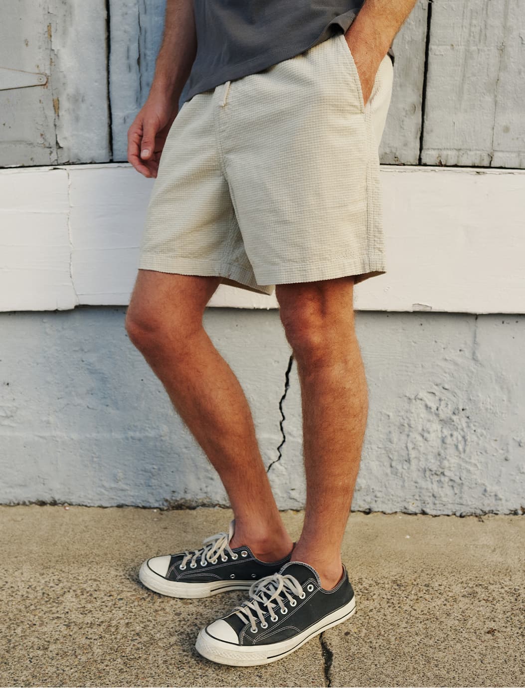 Model wearing the Ward Short leaning up against wall