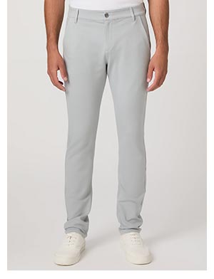A man's legs wearing light steel blue pants and white leather shoes.