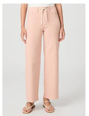 A woman's legs wearing a light pink pant with drawstring closure paired with white sandals.