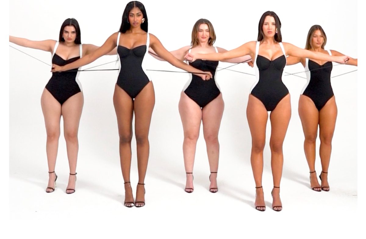 Five women in black swimsuits holding strings, showcasing diverse body types.