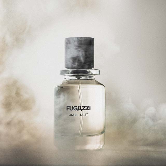 Perfume bottle labeled 'FUGAZZI ANGEL DUST' surrounded by a misty, smoky haze.