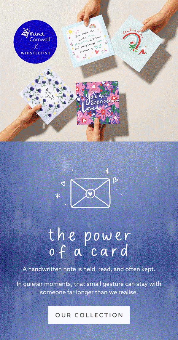 Hands holding a selection of illustrated Whistlefish greeting cards, including floral and uplifting designs, part of the Mind Cornwall collaboration collection.