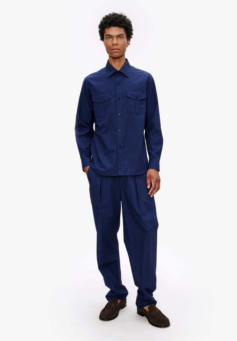 A.P.C. man model standing in blue outfit