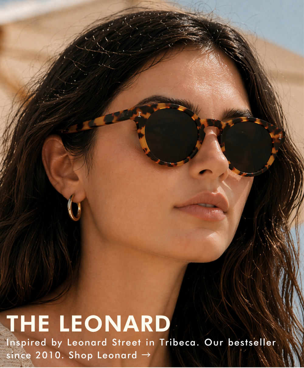 A close-up lifestyle shot of a woman wearing the Leonard sunglasses in a honey-colored tortoise shell with dark lenses. She has wavy dark hair and is wearing a gold hoop earring. The text reads: 