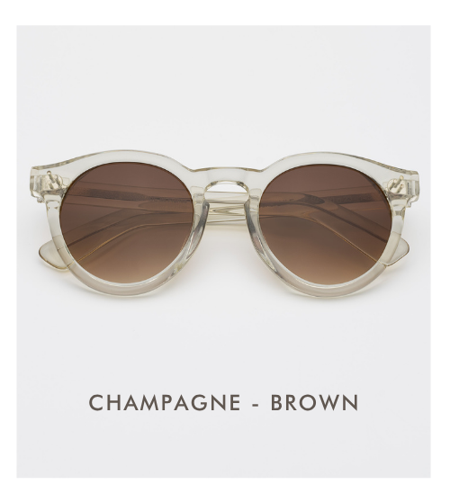 A studio product shot of the Leonard sunglasses in Champagne with Brown lenses. The frames are a clear, pale yellow tint, paired with solid brown lenses.