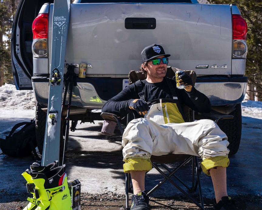 Bernie Rosow sitting behind truck with drink in hand