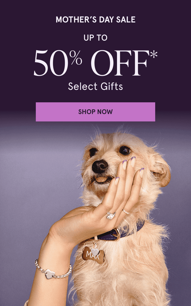 Hand holding dog with diamond ring & charm bracelet.  Mother’s Day Sale. Up to 50% OFF Select Gifts. Click here to shop now