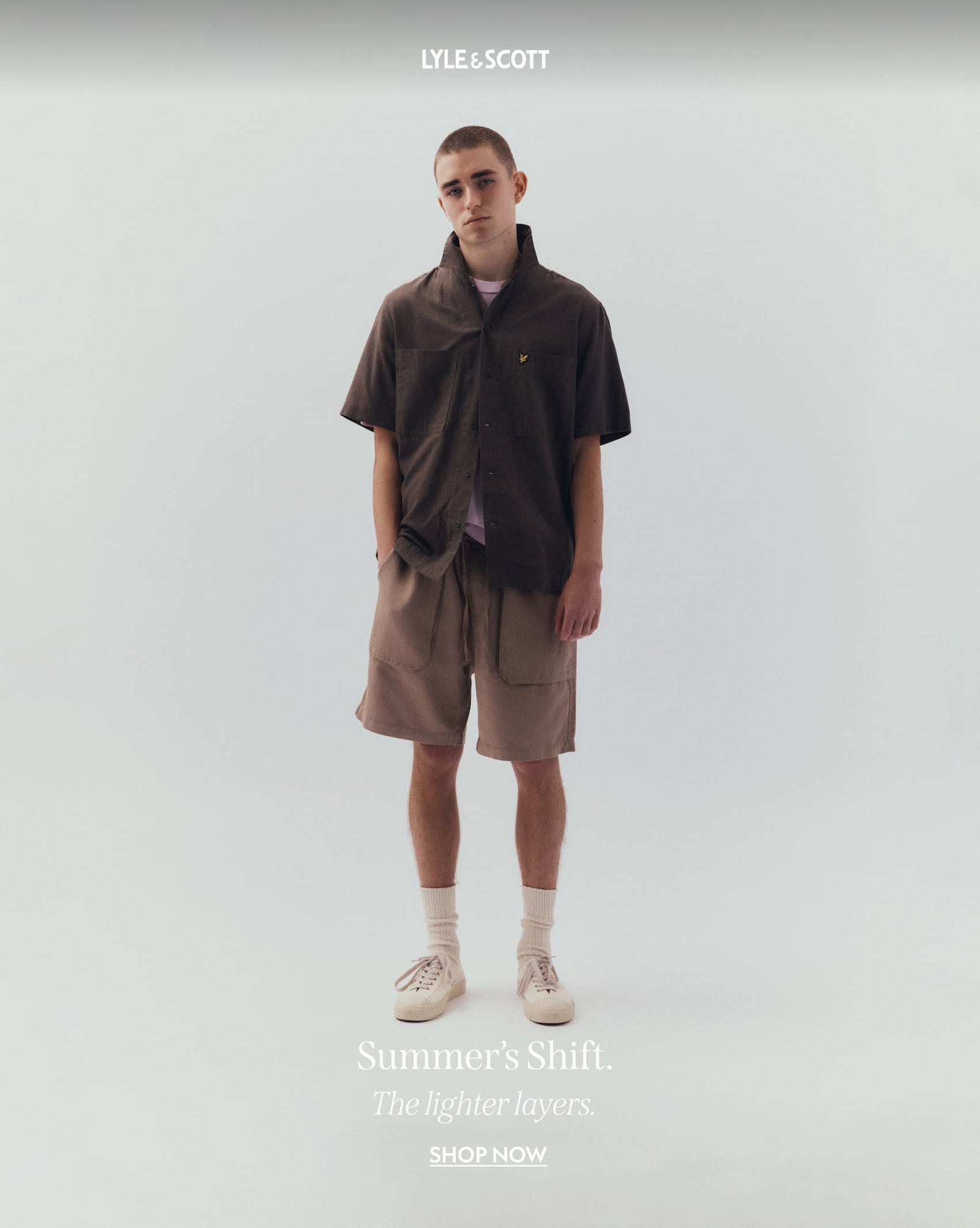 Model wearing short sleeved cotton shirt and linen blend shorts