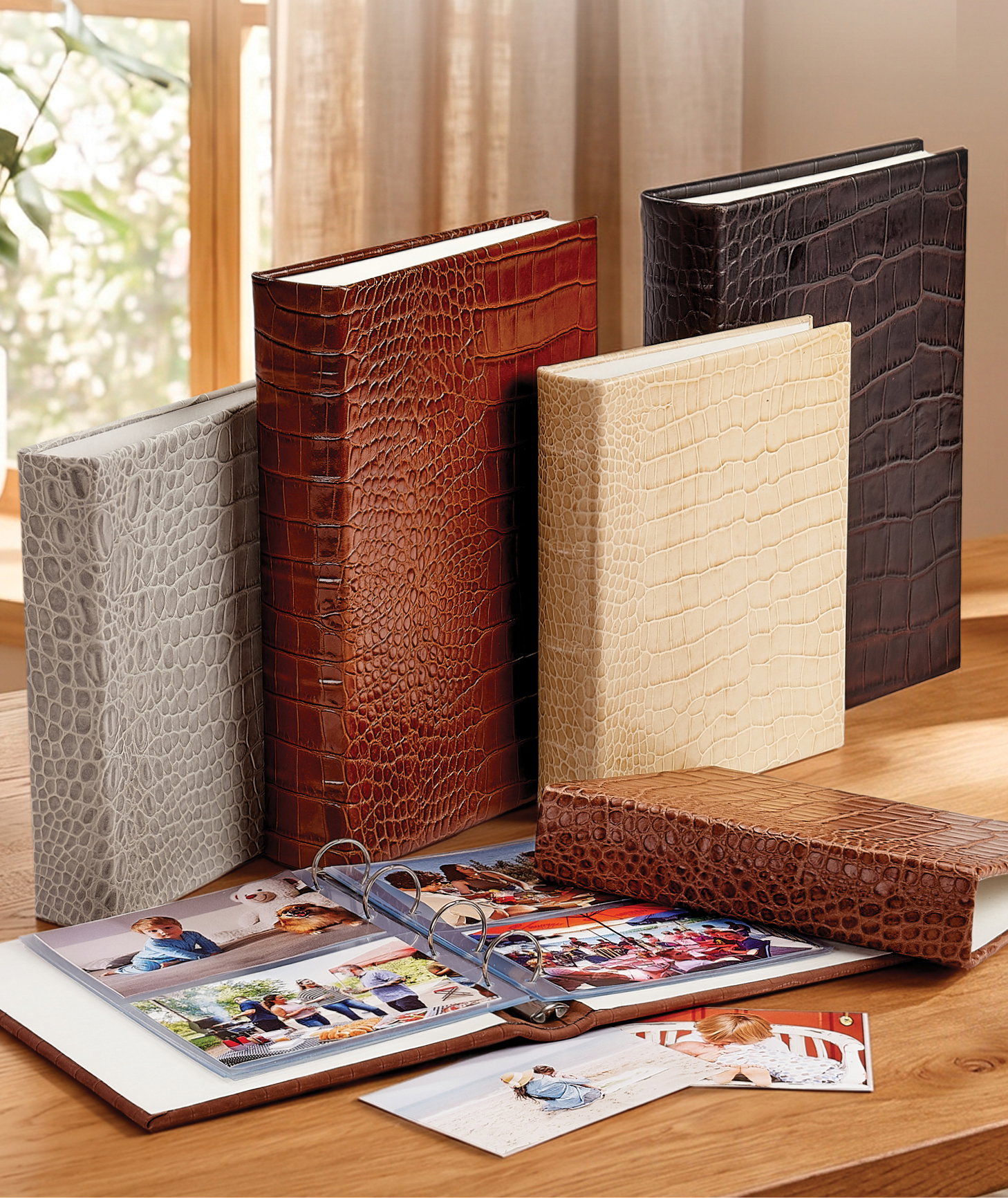 An assortment of leather photo albums in various sizes and finishes.