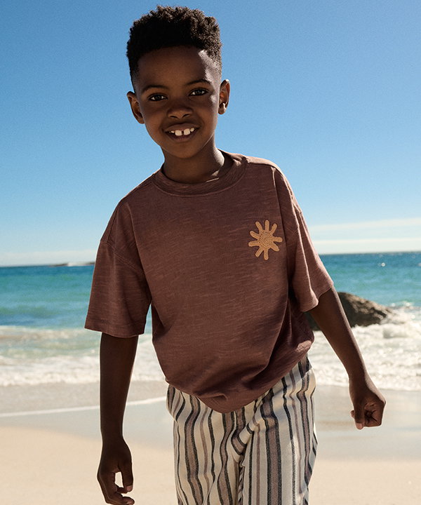 Boy wearing Pure Cotton Embroidered T-Shirt in Mocha with Pure Cotton Textured Striped Trousers in Multi Neutral