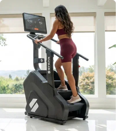 Woman in burgundy outfit using the STEPR Pro plus in bright and sunny room