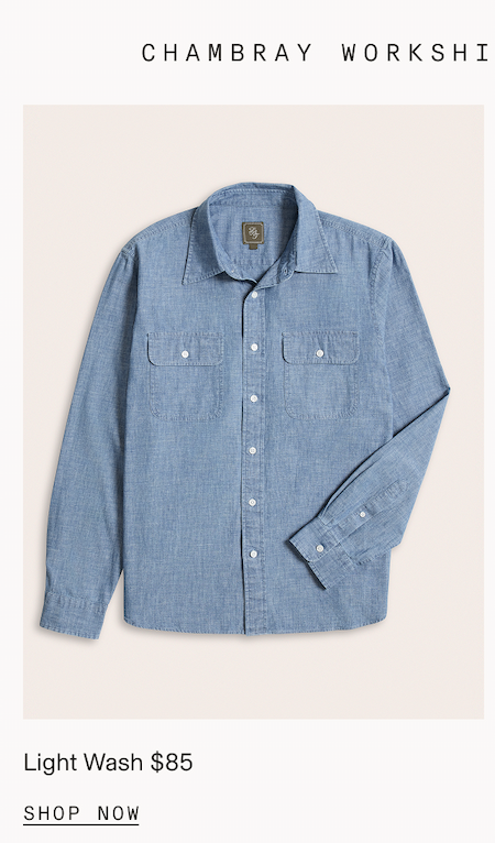 Flat lay of a light blue chambray workshirt with a camp collar, dual chest pockets, and white buttons. Partial header text reads: "CHAMBRAY WORKSHI." Below the image: "Light Wash $85." CTA: "SHOP NOW"
