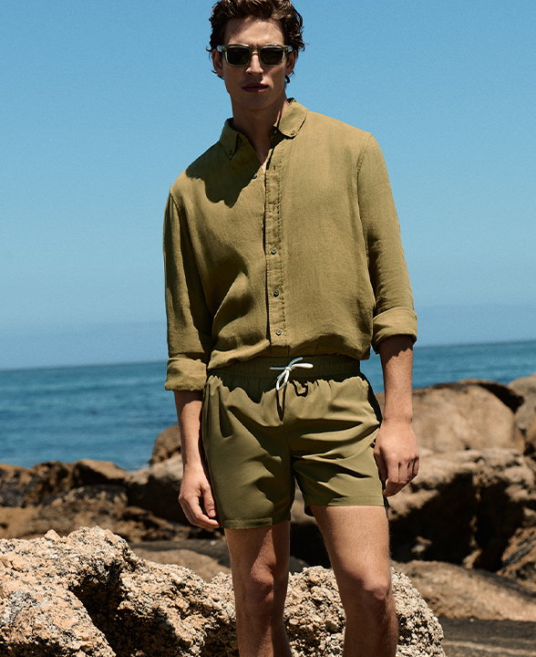 Man wearing Pure Linen Garment Dye Shirt in Olive with Quick Dry Plain Swim Shorts in Olive