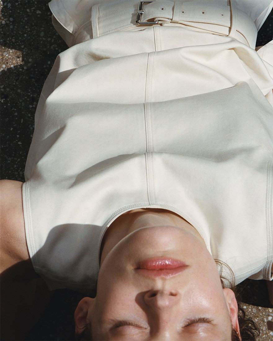 Cropped image of model laying upside down wearing the Nerina Top in Cotton Drill in Marzipan with the Nila Pant in Cotton Drill in Marzipan
