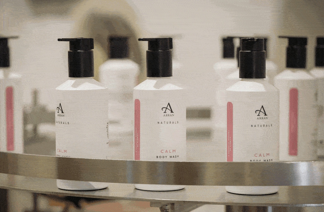 a gif of our CALM body washes being labelled in the factory
