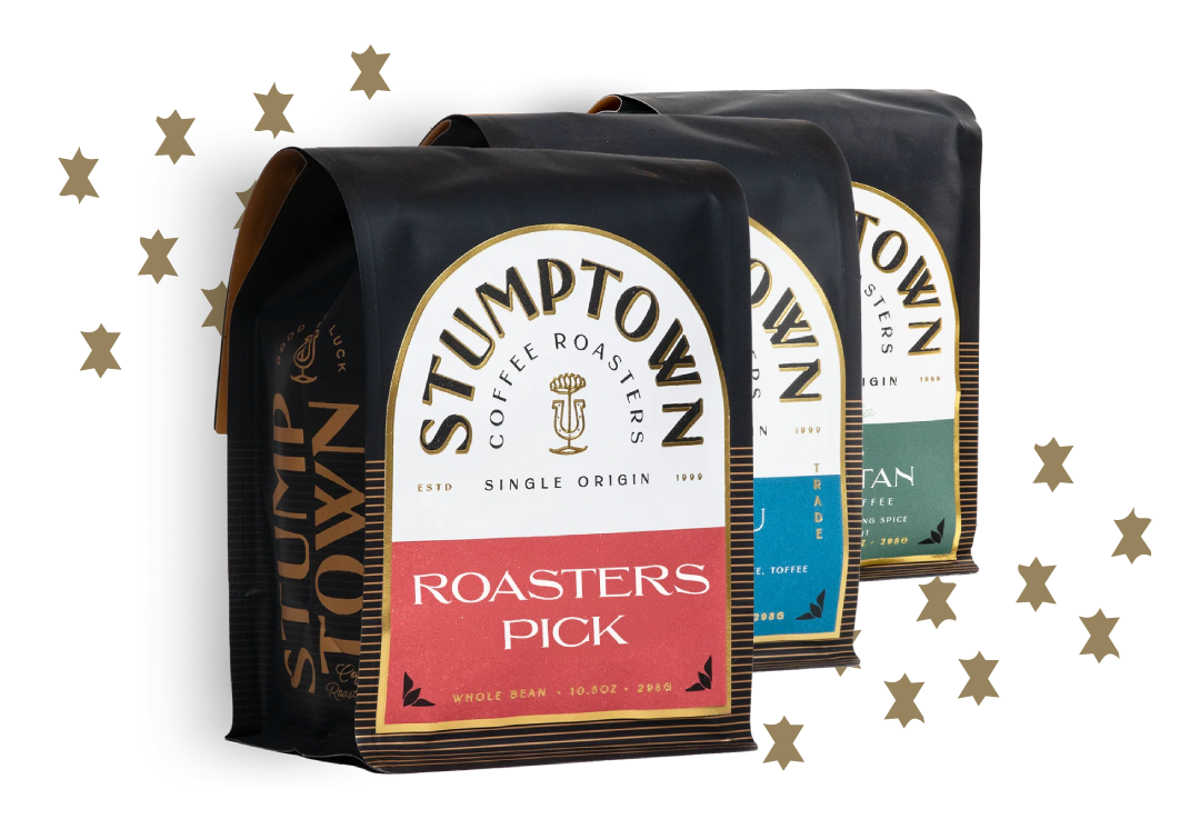 Three Stumptown Roaster’s Pick coffee bags with gold stars on a light background.
