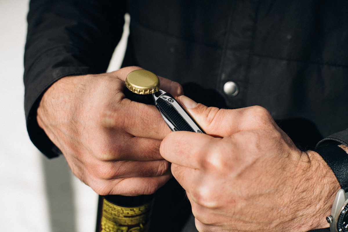 The Ellis prying bottle cap open