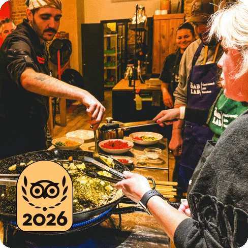 Image Description: Four people with bowls of ingredients learning how to make food. A gold 2026 Travellers’ Choice Best of the Best badge is on the image.
