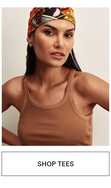 Woman wearing a colorful headscarf and a sleeveless brown ribbed tank top, posing against a neutral background. Below is a button labeled "Shop Tees.