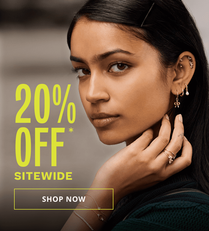 Close up on model’s ear stack with gold huggies, dangling charms & pink gemstone climbers. 20% OFF Sitewide. Click here to shop now