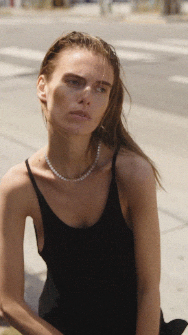 GIF of model wearing Floating eternity necklace in diamond and enamel moissanite necklace in noir.