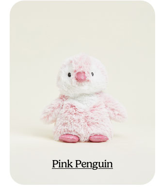 Pink Penguin Warmies on a beige background. Shop Now.