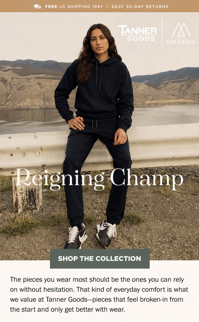 Man in black Reigning Champ sweatshirt and sweatpants sitting on a guard-rail
